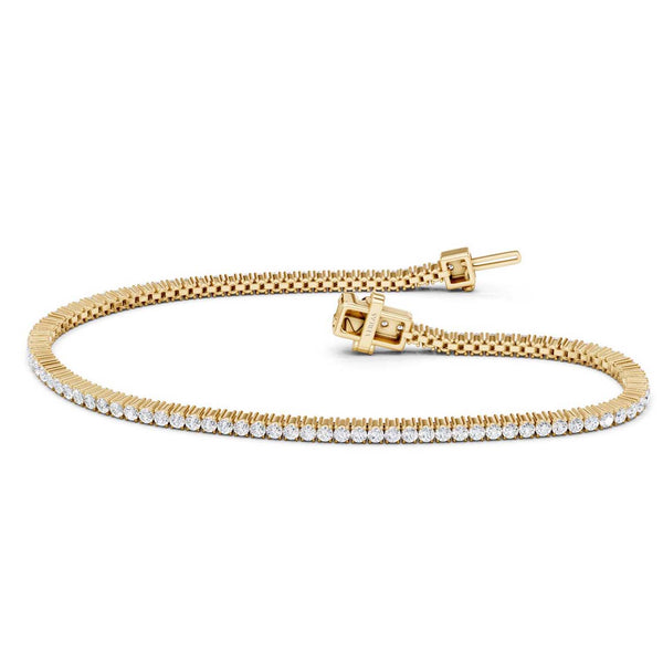 A yellow gold tennis bracelet featuring a row of clear pavé-set round diamonds along the front band and a central flower-shaped diamond cluster, photographed on a clean white background.